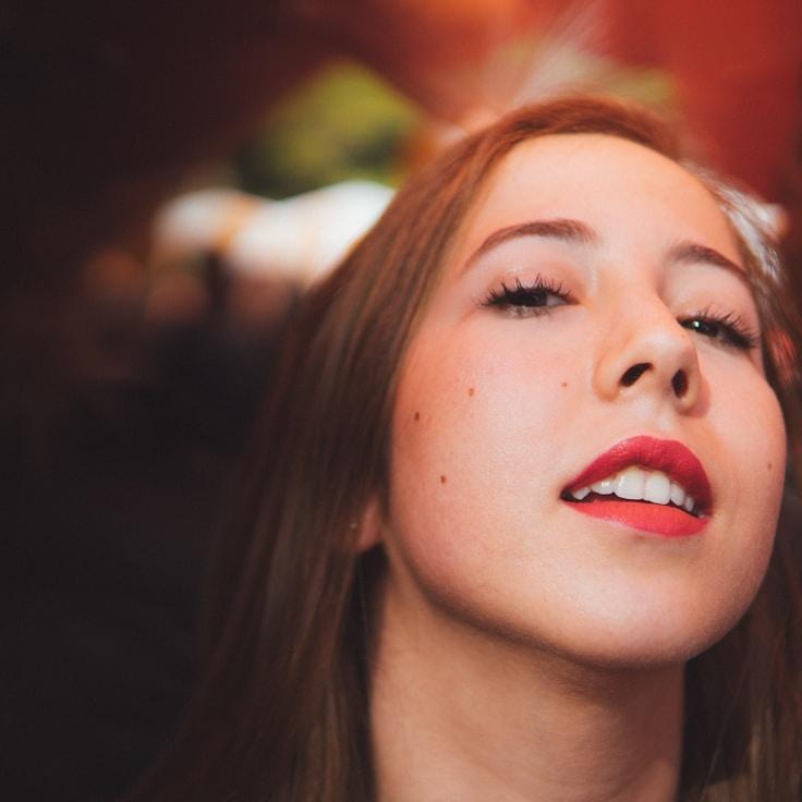 Kaveri Mehta, Lead Design Curator at Whisper Ocean Valley, reviewing corporate floral arrangements